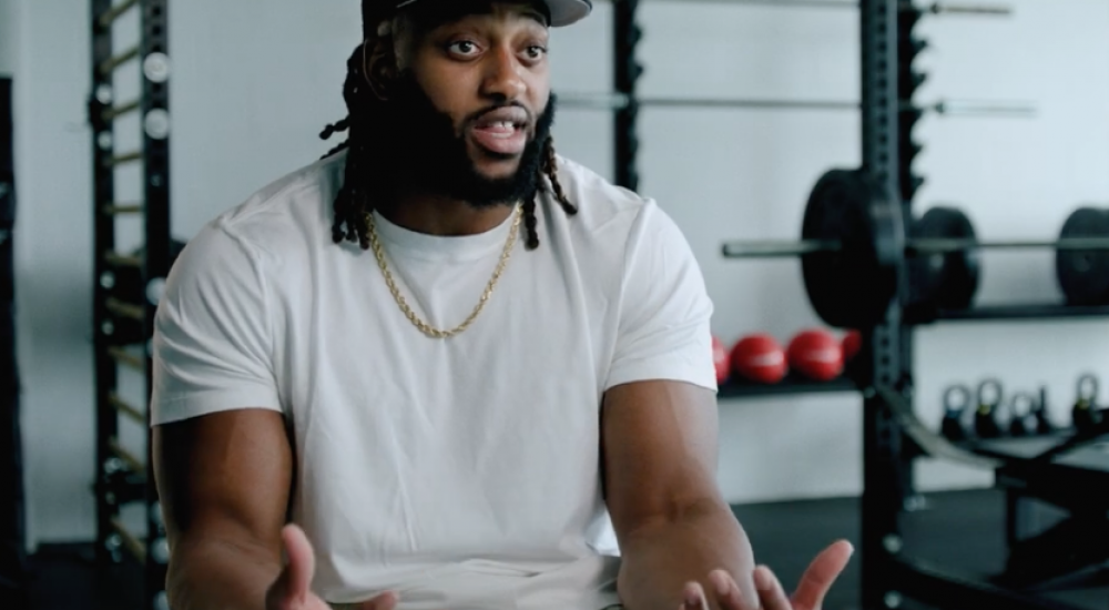 Man sitting in a gym for an interview style video